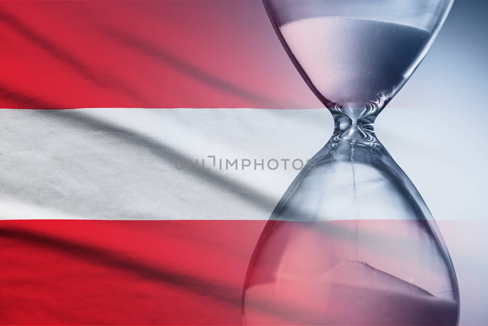 Flag of Austria with superimposed hourglass with running sand conceptual of deadlines, countdown, passing time, urgency, crisis and time management