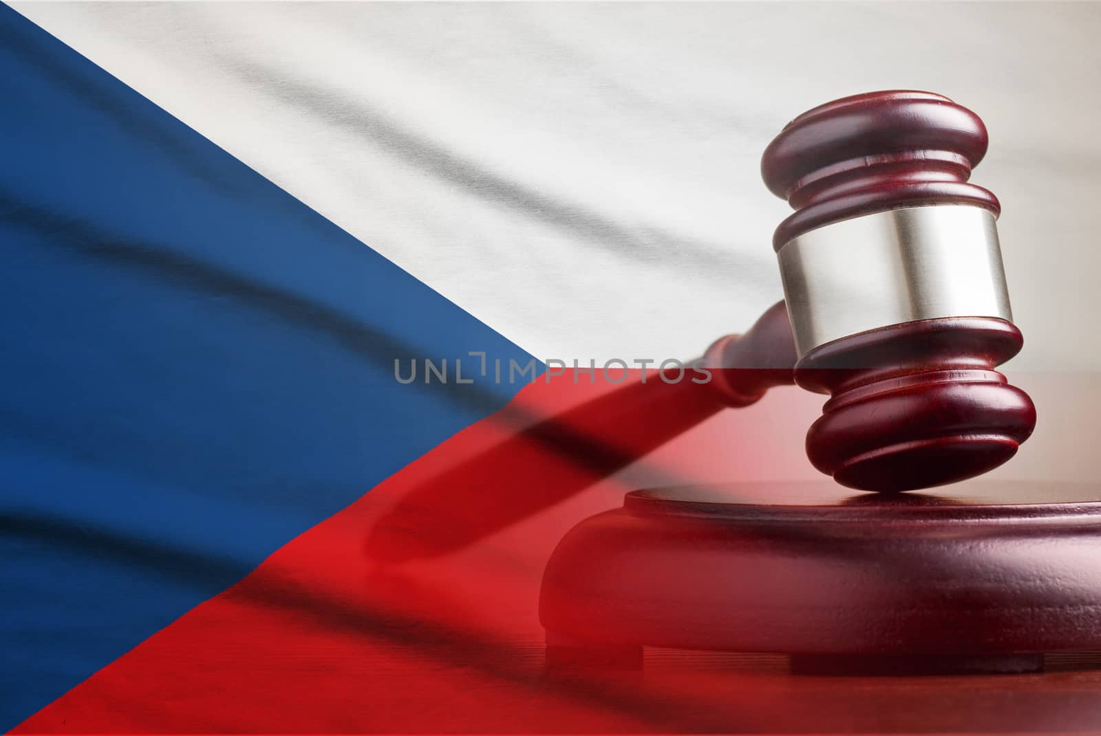 Legal gavel on its plinth over a flag of the Czech Republic in a conceptual composite image