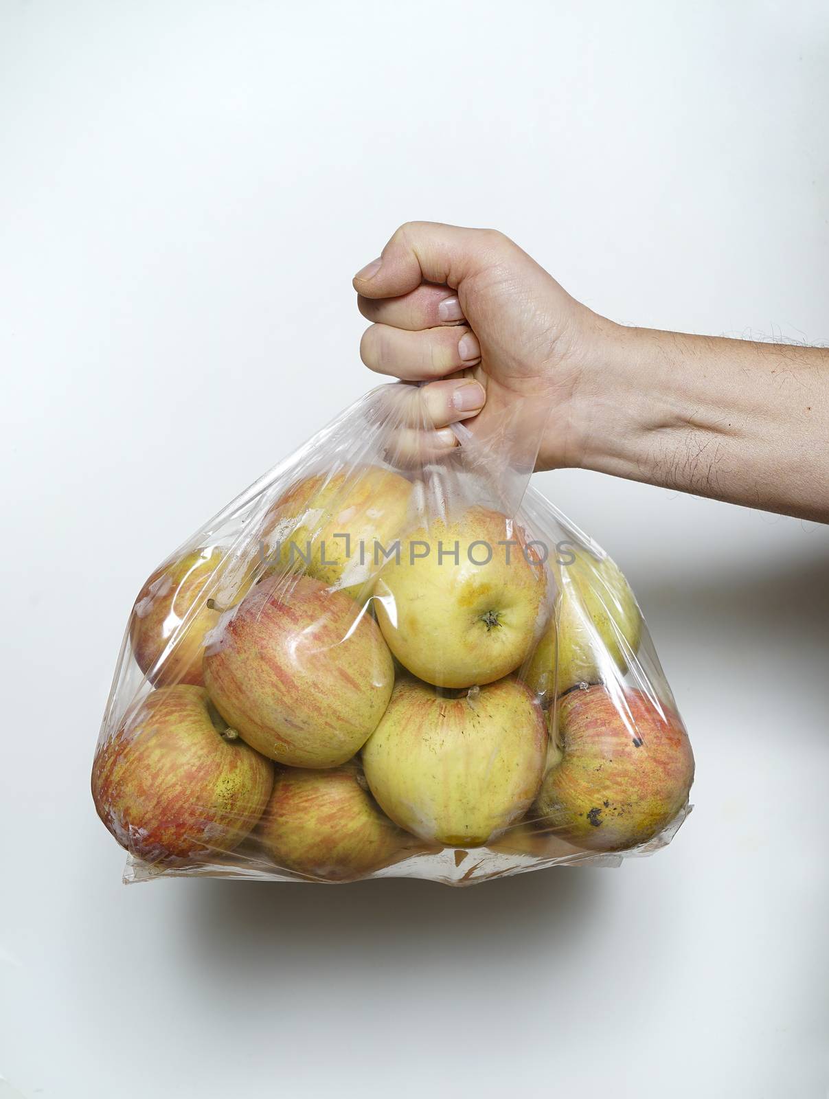 some apples in a plastic bag