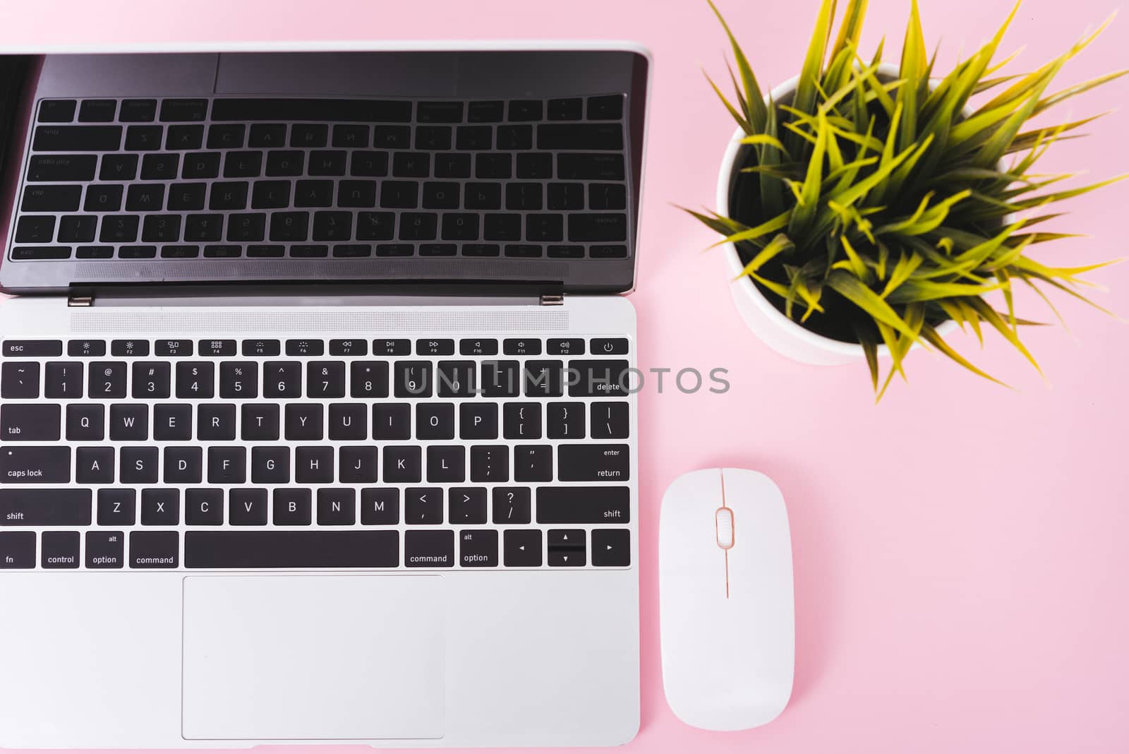 Top view of modern technology smart phone mobile and computer laptop on pink background with copy space