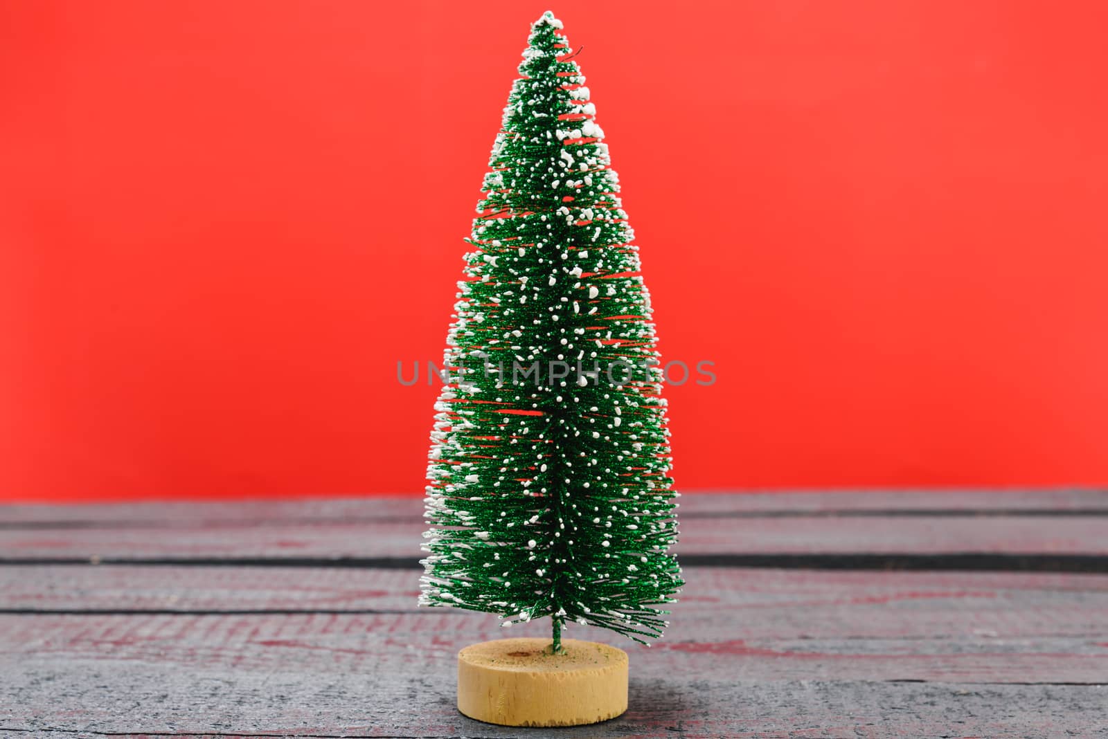 Christmas composition decorations, minimal green fir tree branches with snow on red background. Merry Christmas concept. Copy space for text