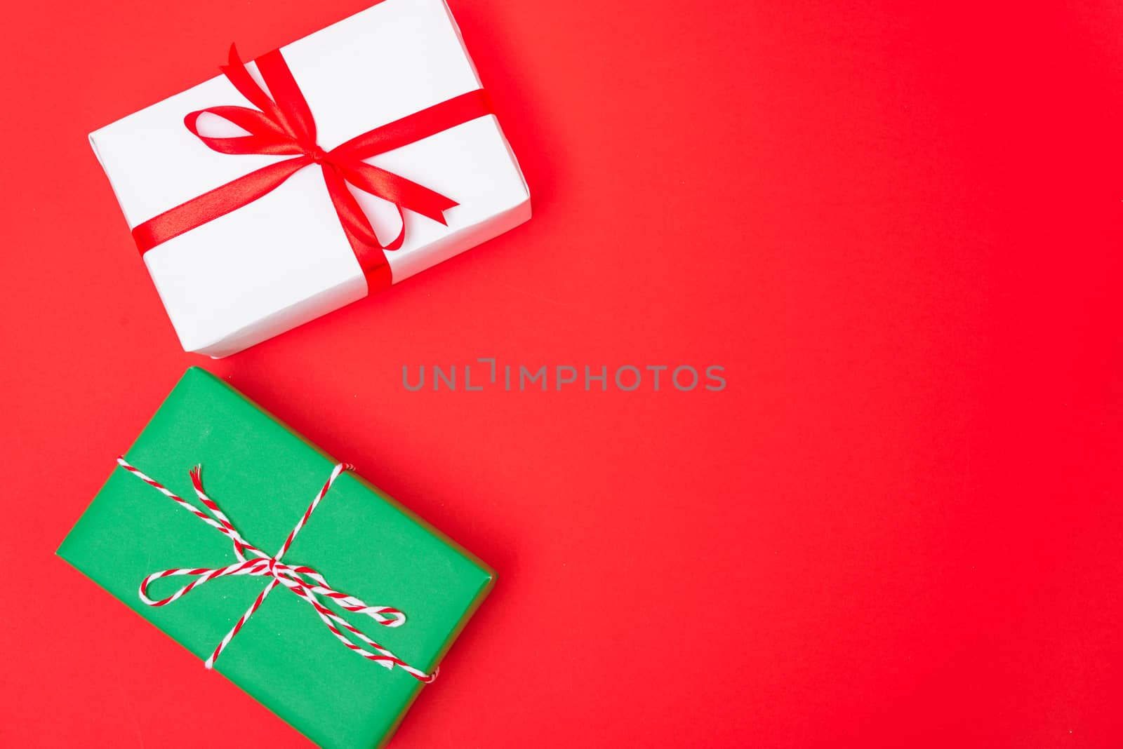 Happy New Year and Christmas 2020 day, top view Xmas white and green gift boxes on red background with copy space for your text
