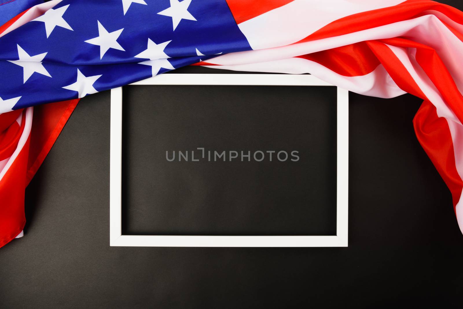 Martin luther king day, flat lay top view, American flag and photo frame on black background with copy space for your text
