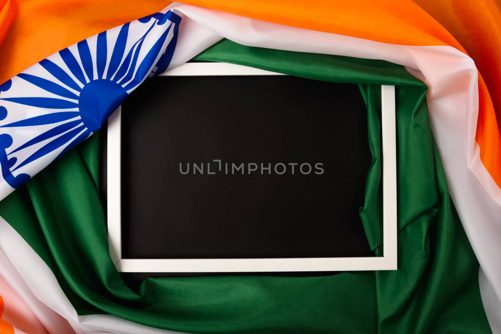 Indian republic day, flat lay top view, Indian flag and photo frame on black background with copy space for your text