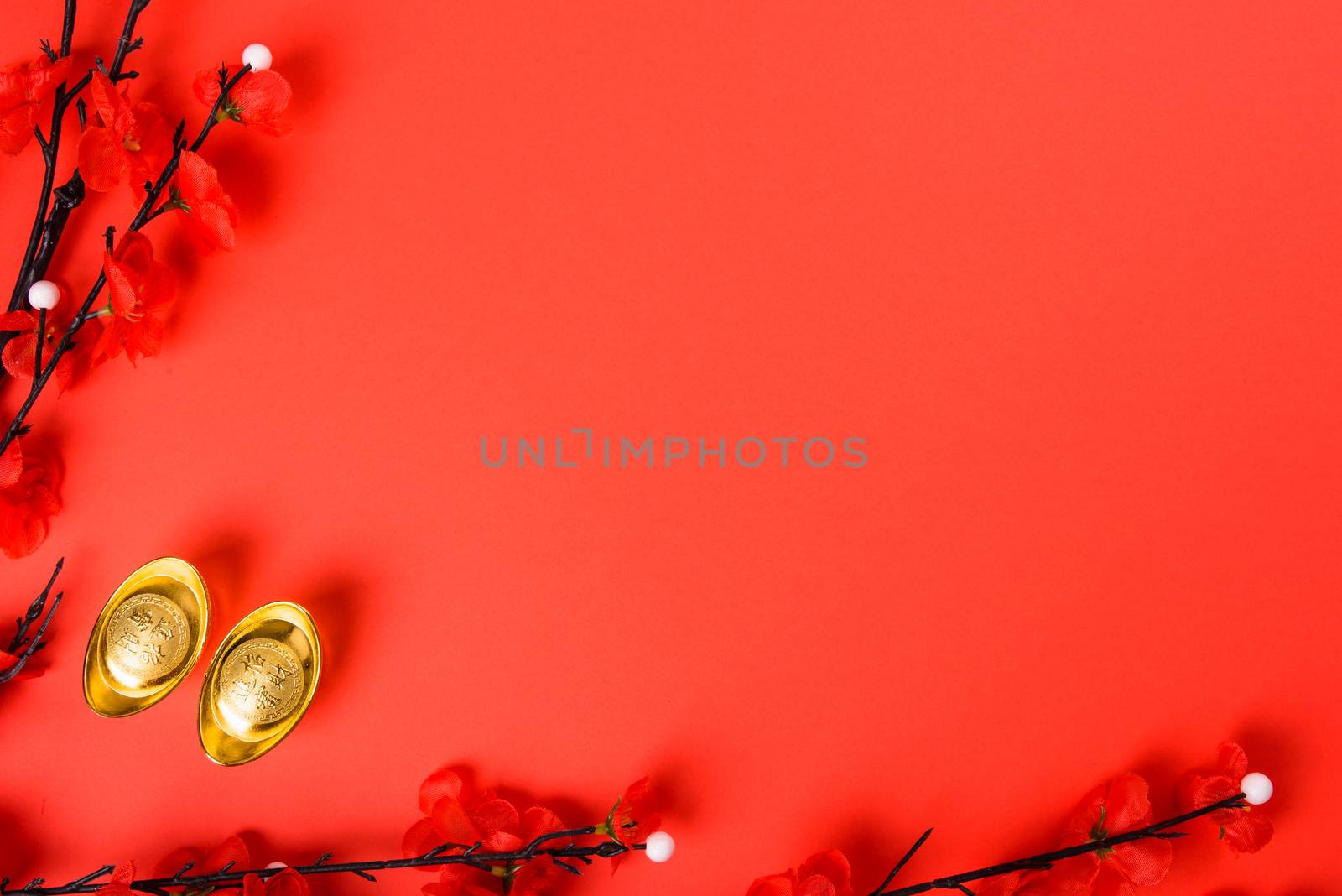 Chinese New Year, flat lay top view, gold bar and Chinese Flower on red background with copy space for your text