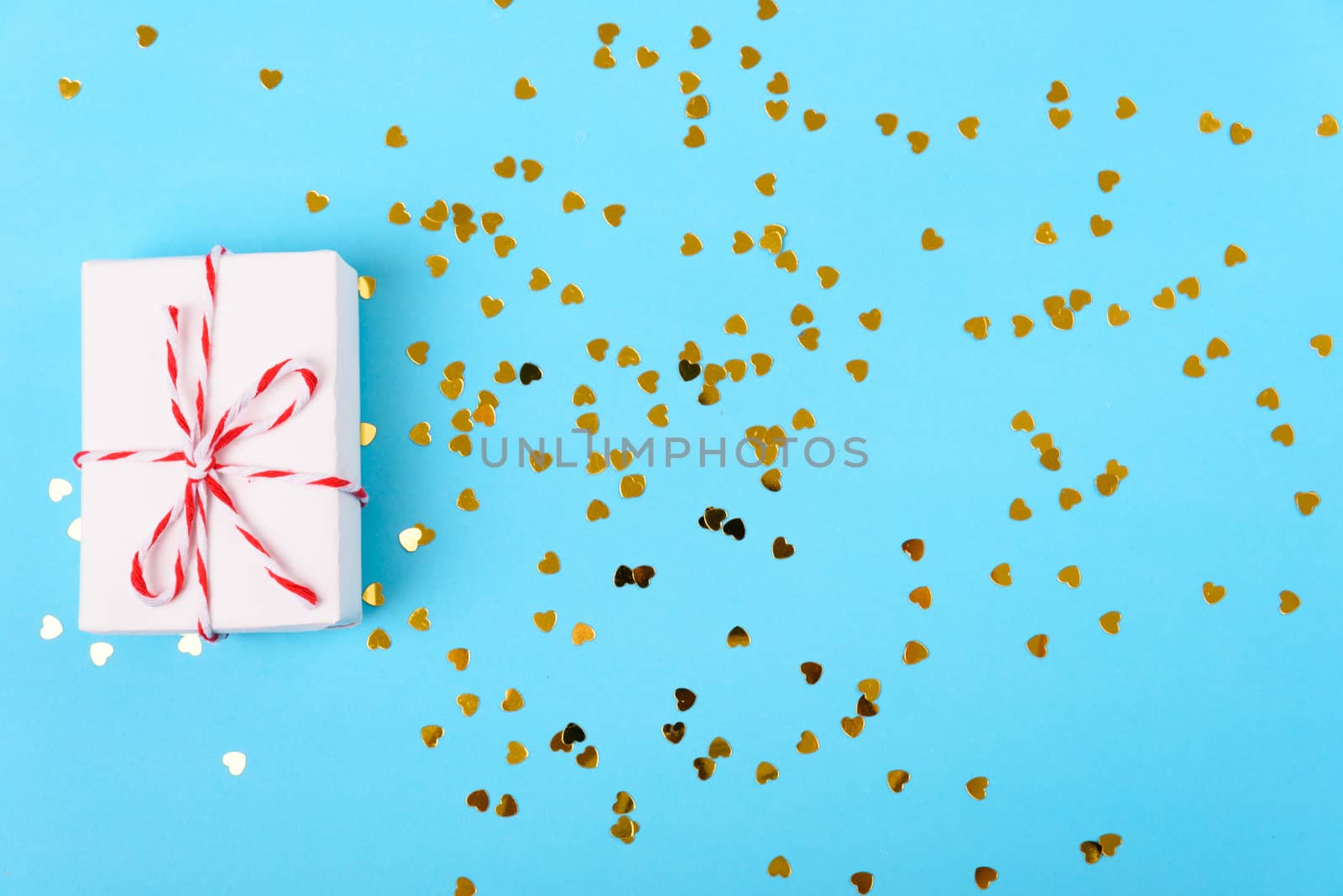 Valentine's day Concept, flat lay top view, White Gift Box and Red Heart on Blue background with copy space for your text