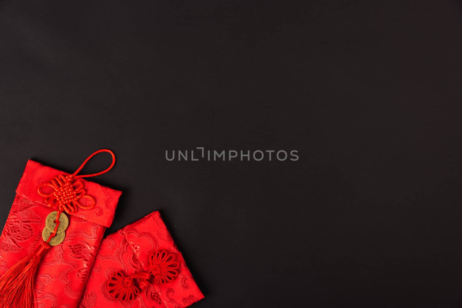 Chinese new year festival concept, flat lay top view, Happy Chinese new year with Red envelope (Character "FU" means fortune, blessing, wealth) on black background with copy space for your text