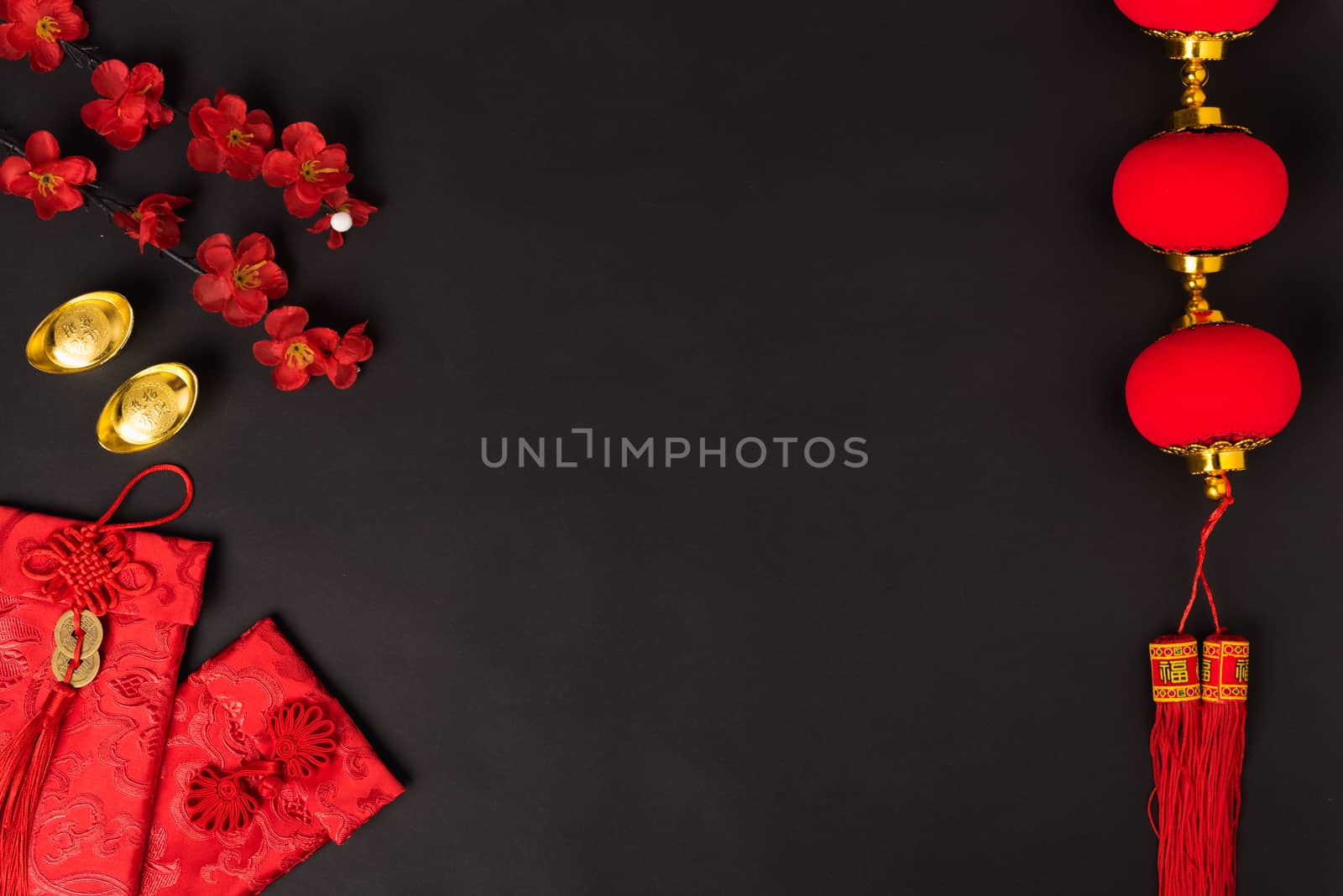 Chinese new year concept, flat lay top view, Happy Chinese new year with Red envelope and gold ingot (Character "FU" means fortune, blessing, wealth) on black background with copy space for your text