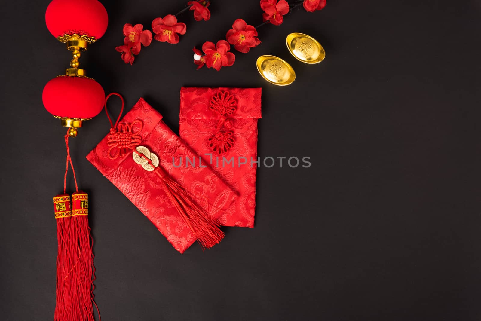 Chinese new year concept, flat lay top view, Happy Chinese new year with Red envelope and gold ingot (Character "FU" means fortune, blessing, wealth) on black background with copy space for your text