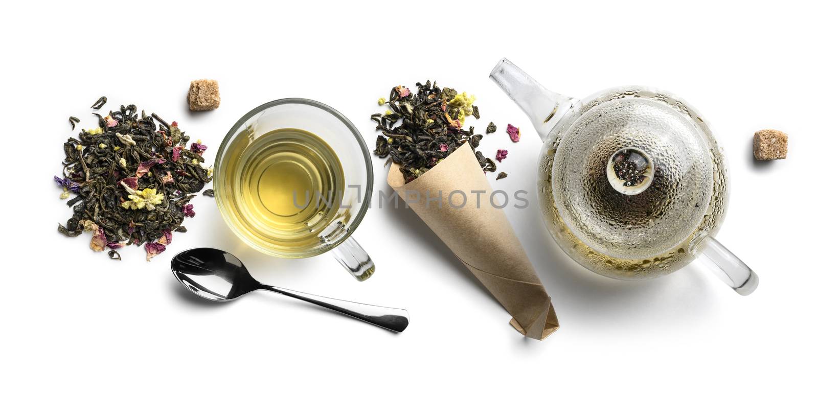 Green tea with natural aromatic additives and accessories. Top view on white background.