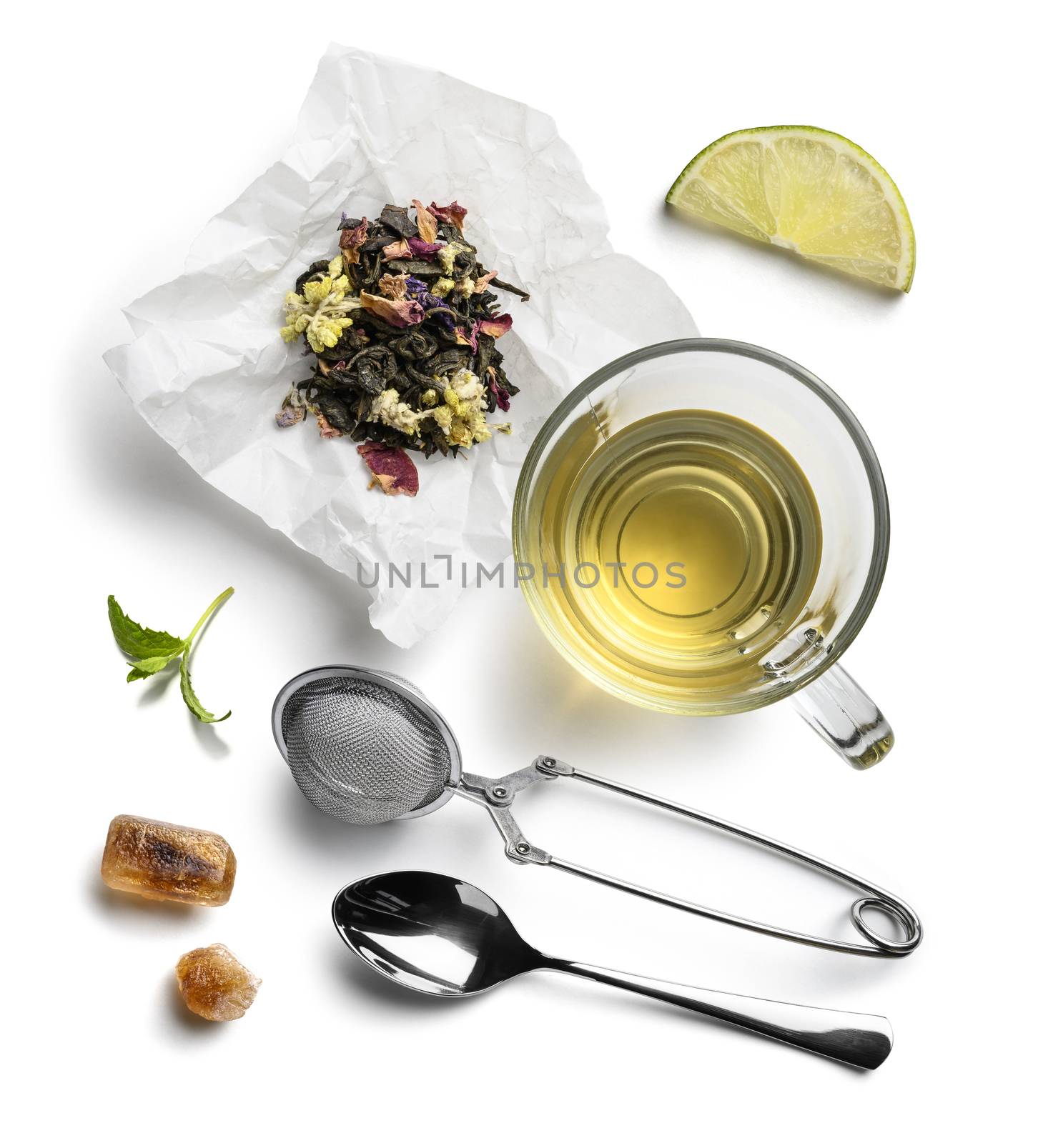 Green tea with natural aromatic additives and accessories. Top view on white background.