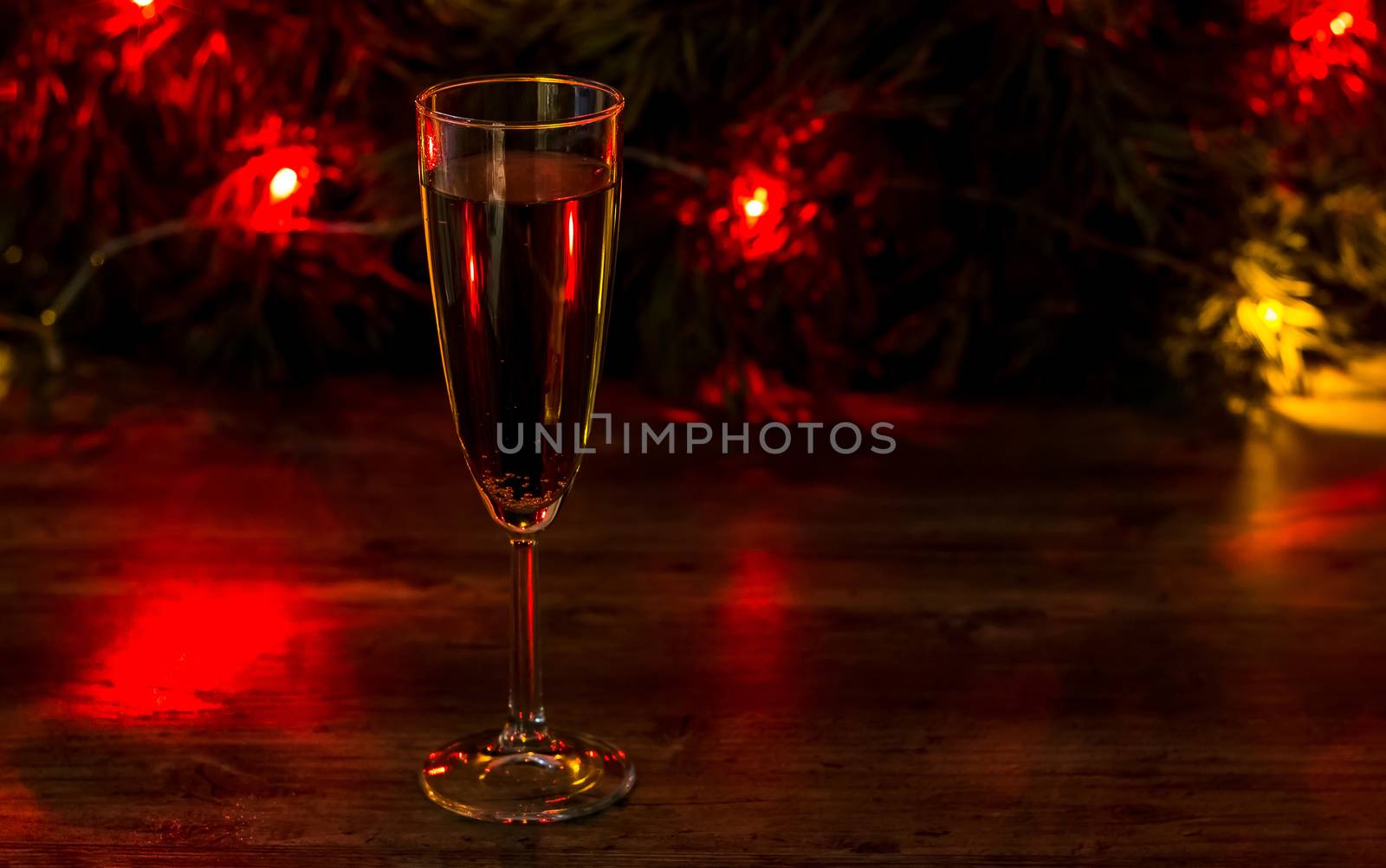 A glass of champagne on the background of a Christmas tree with  by YevgeniySam