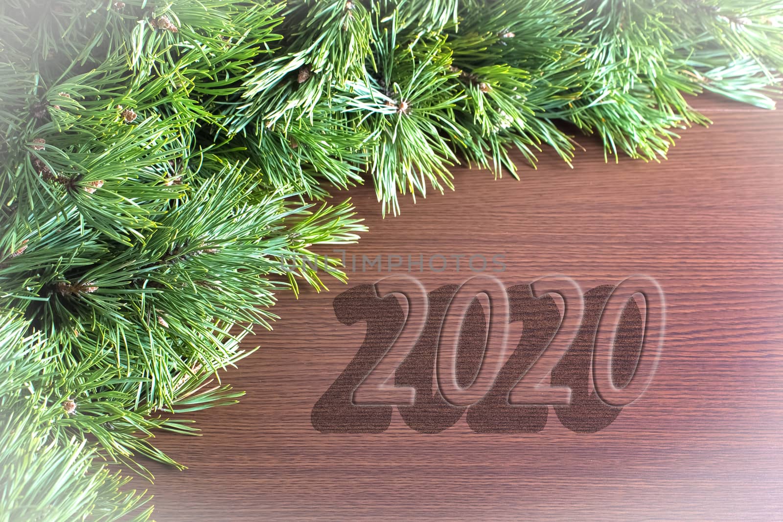 Christmas tree branches on a wooden table with the inscription 2 by YevgeniySam