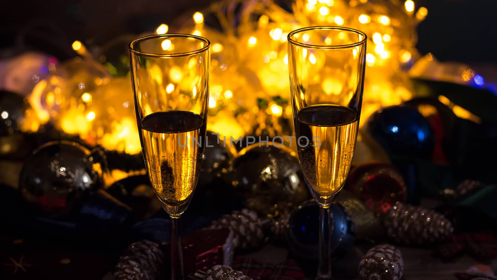 Glasses of champagne on the Christmas table with Christmas toys  by YevgeniySam