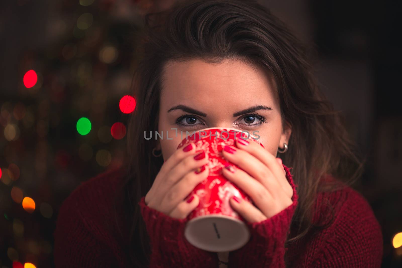 Woman holding winter cup with nice Christmas motive close up on Christmas background. Winter and Christmas time concept. by petrsvoboda91