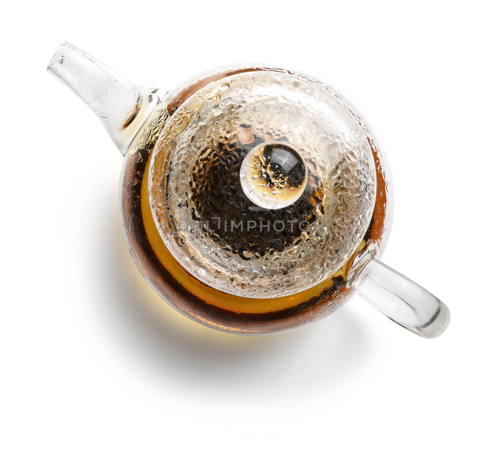 Glass teapot with tea on white background. The view from the top.