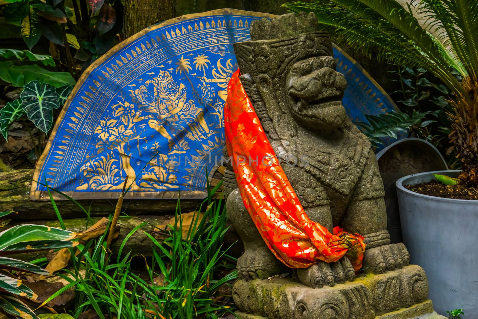 Traditional asian decorations in a a garden, feng shui lion with an fan and canvas