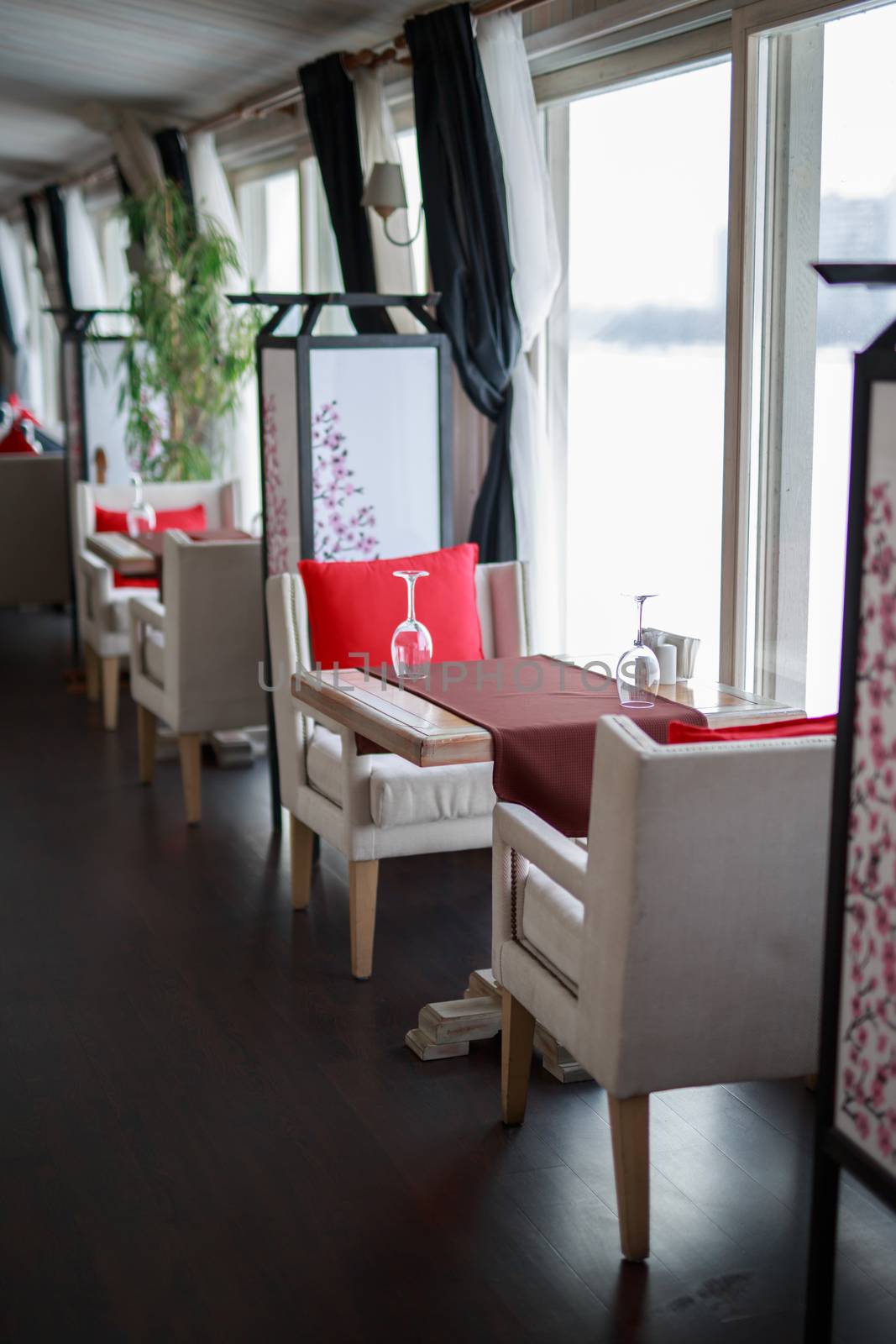 table near the window of a large light window, restaurant cozy interior texture of a wooden wall