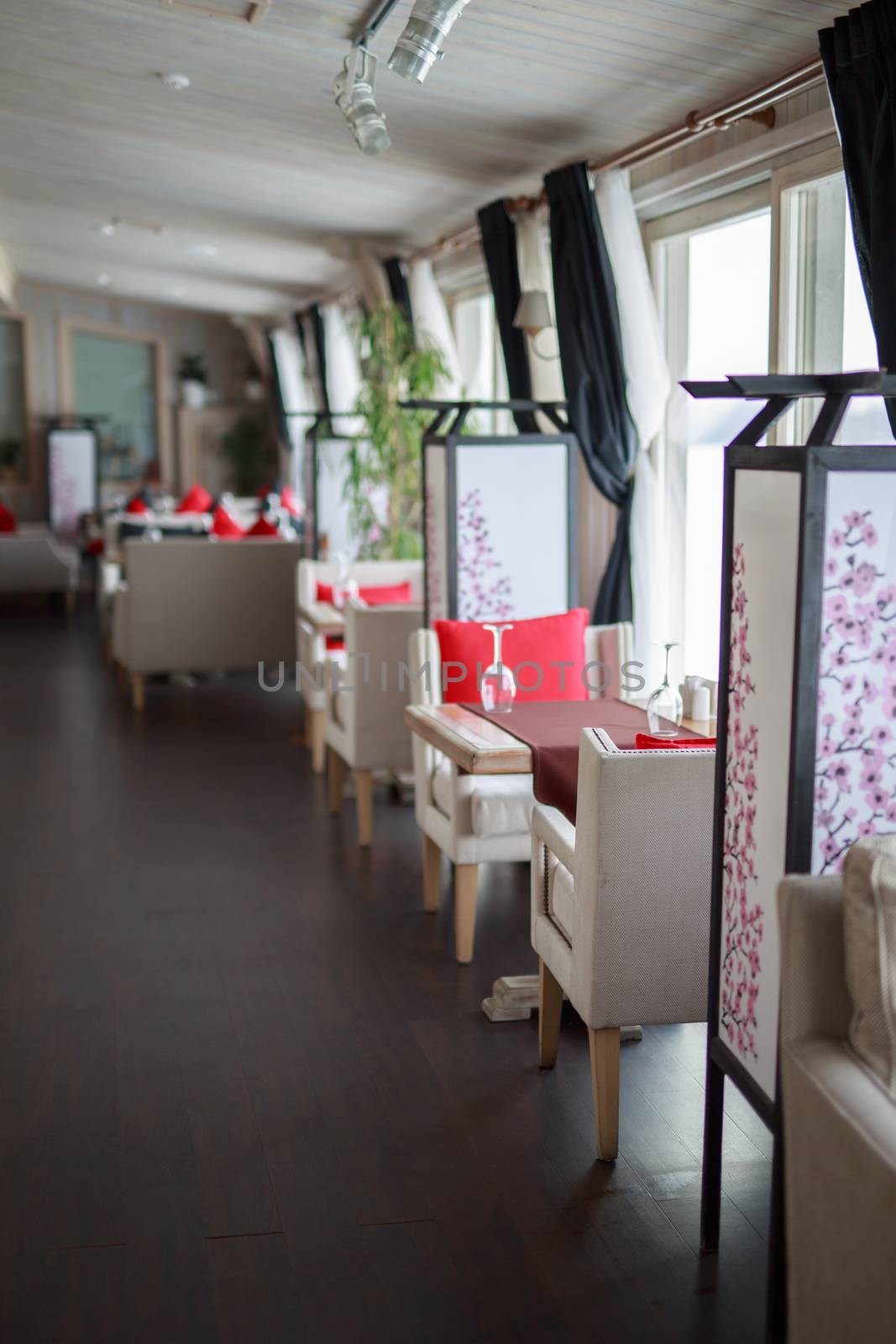 table near the window of a large light window, restaurant cozy interior texture of a wooden wall