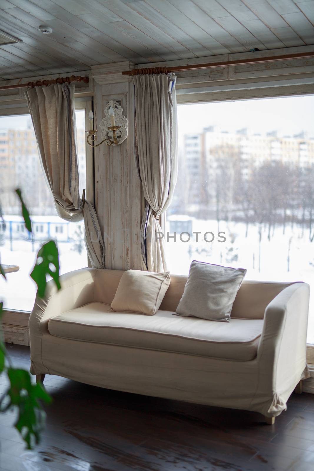 table near the window of a large light window, restaurant cozy interior texture of a wooden wallsofa near the window of a large light window, restaurant cozy interior texture of a wooden wall by dikkens