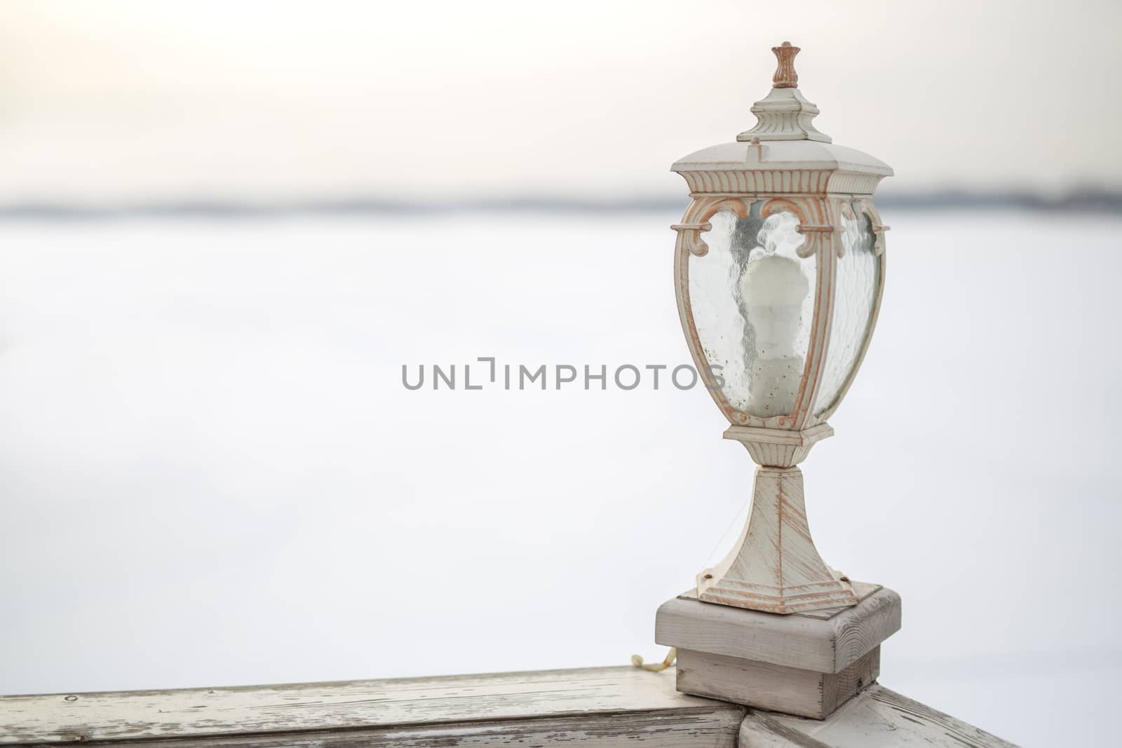 decorative white wooden lantern on Board ship, winter frosty white background by dikkens