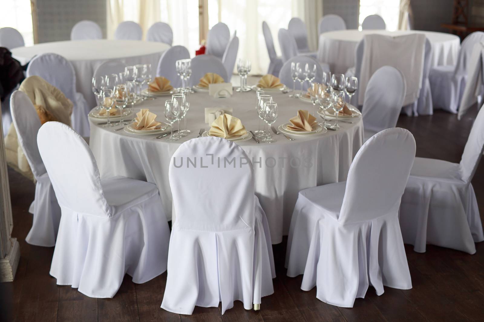 Banquet hall chairs, white tablecloth, food table, table setting, empty wine glasses, Banquet hall without people, wooden floor