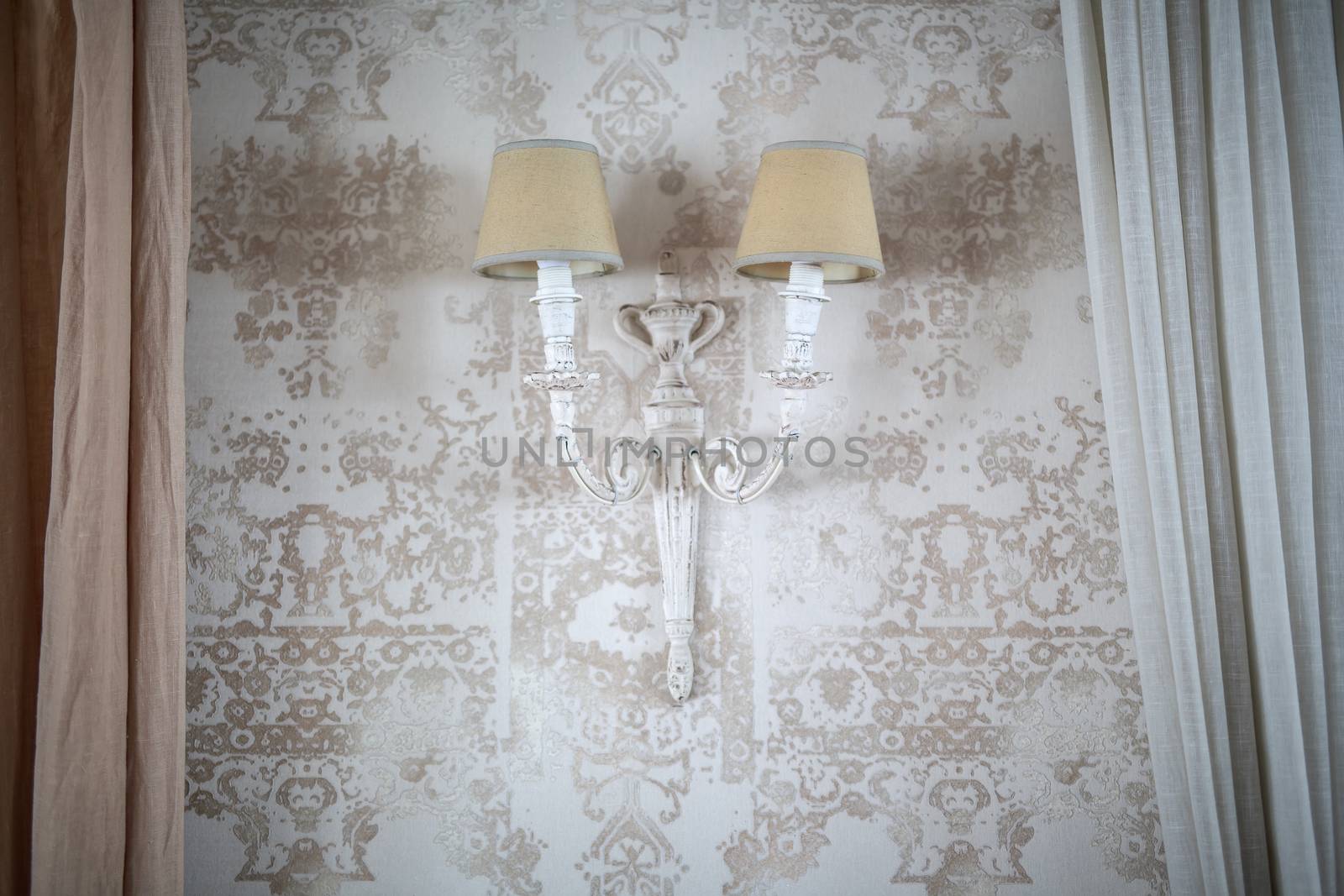 vintage lamp on the wall with Wallpaper with a floral pattern on edges of curtains