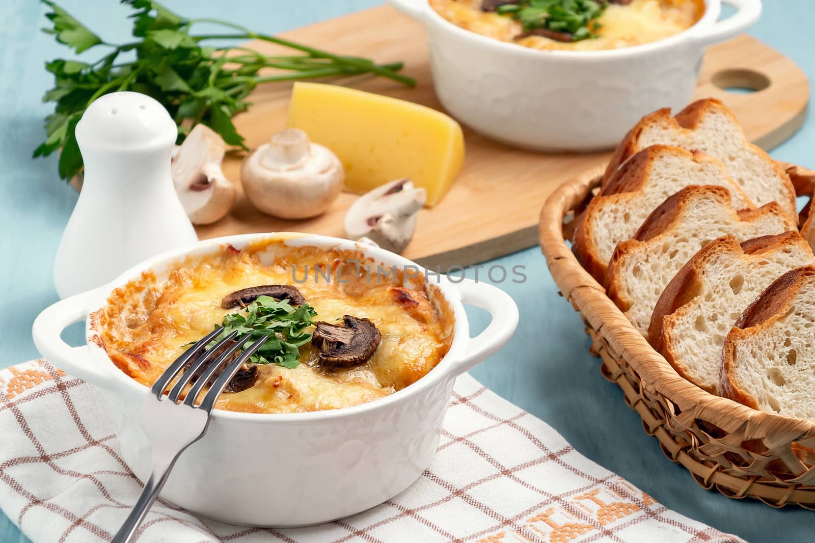 Casserole with chicken, mushrooms and cheese, known in Russia as julienne in white bowl with herbs by galsand