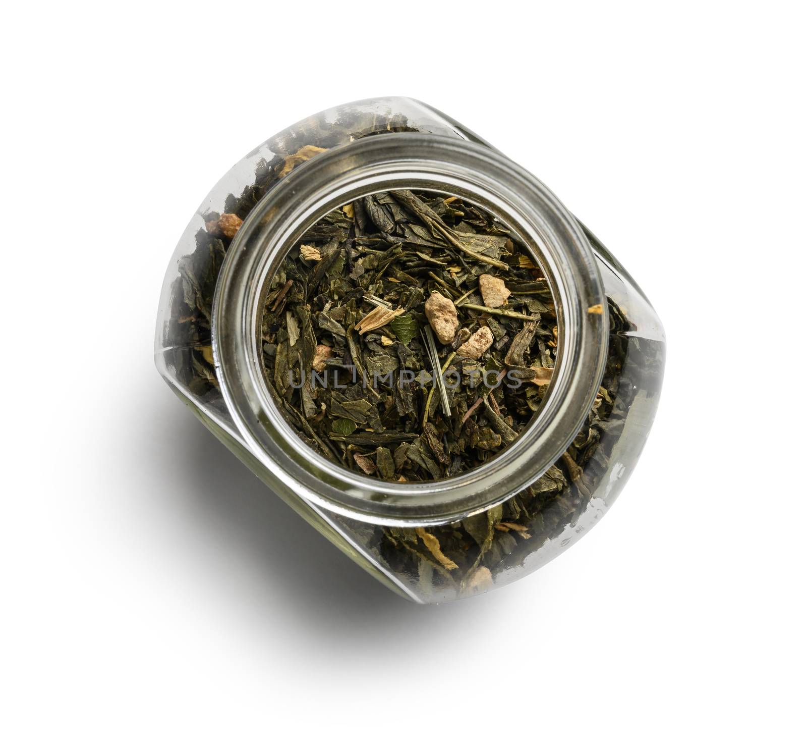 Green tea with aromatic additives. Top view on white background.