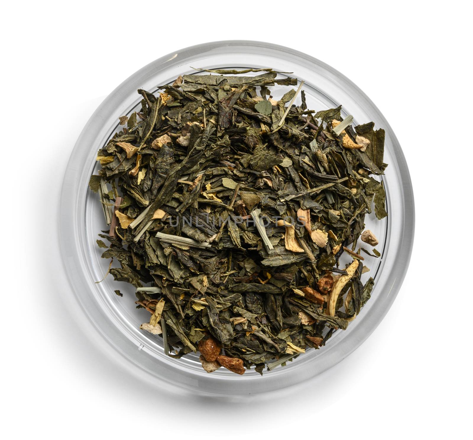 Green tea with aromatic additives. Top view on white background.