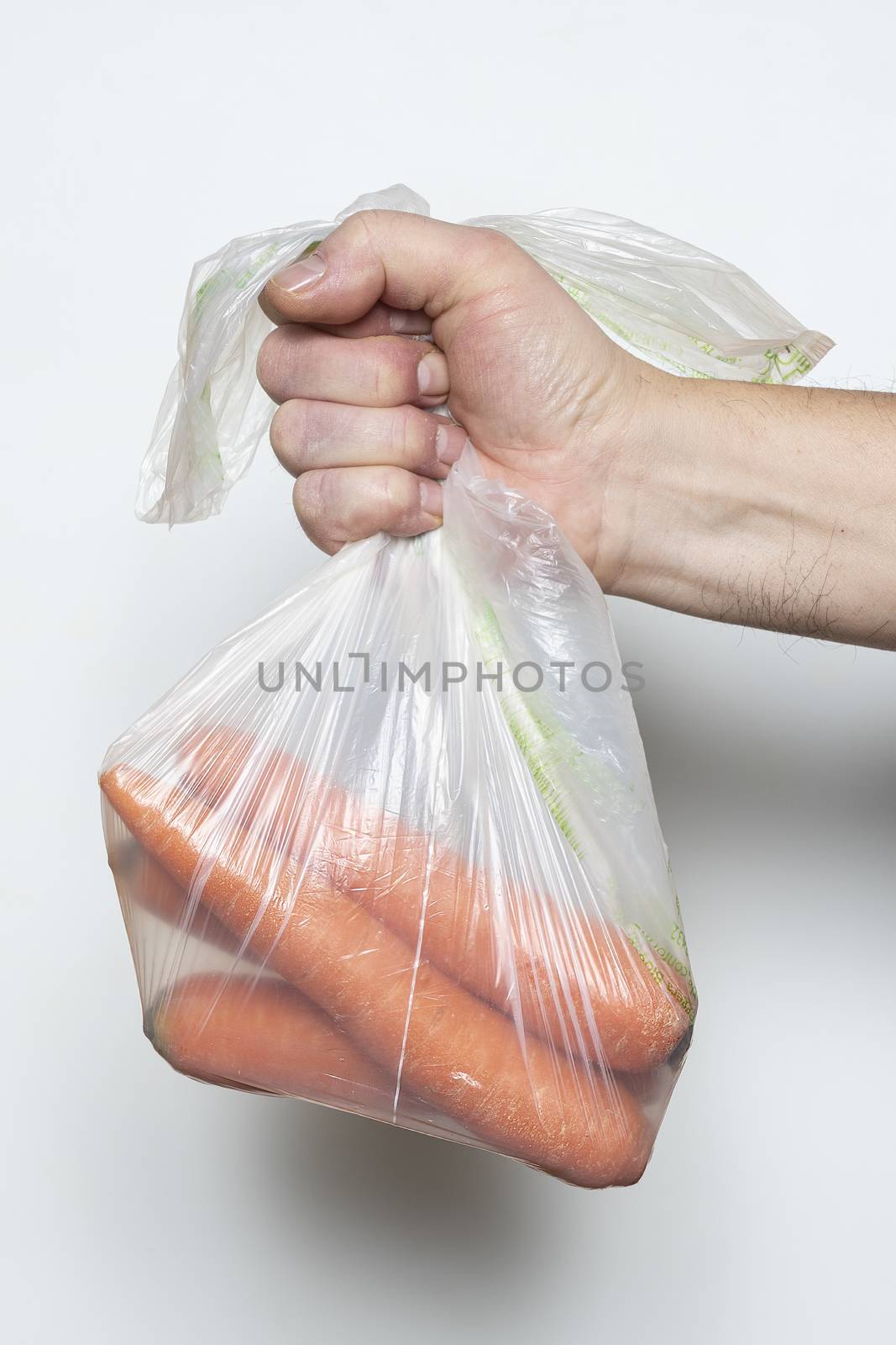 Some carrots in a plastic bag