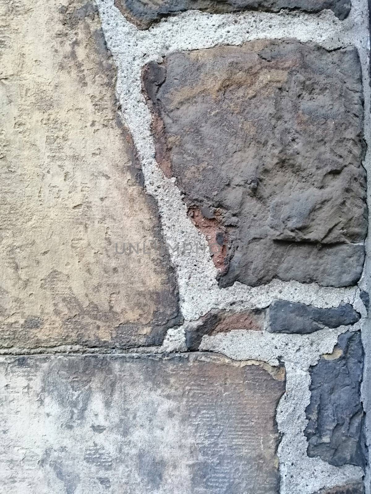 Old stone wall with holes texture background.