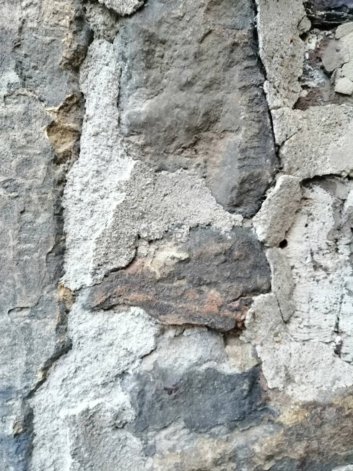 Old stone wall with holes texture background.