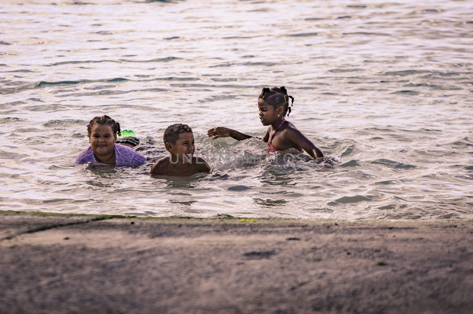 BAYAHIBE, DOMINICAN REPUBLIC 23 DECEMBER 2019: Poor Dominican children play in Bayahibe beach in total happiness and joy