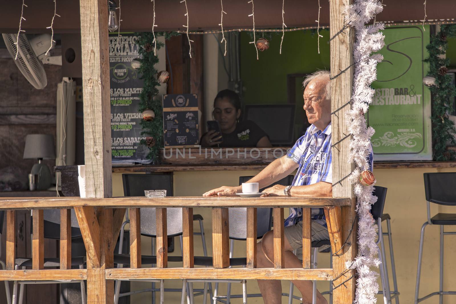 BAYAHIBE, DOMINICAN REPUBLIC 23 DECEMBER 2019: Dominican bar balcony with people