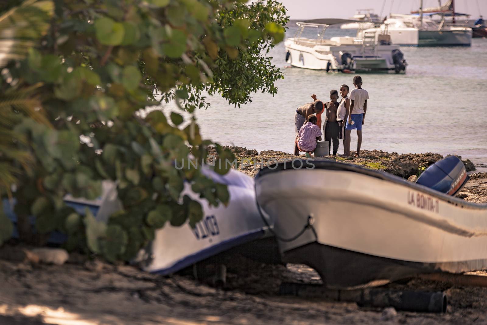 BAYAHIBE, DOMINICAN REPUBLIC 23 DECEMBER 2019: Poor Dominican children play in Bayahibe beach in total happiness and joy