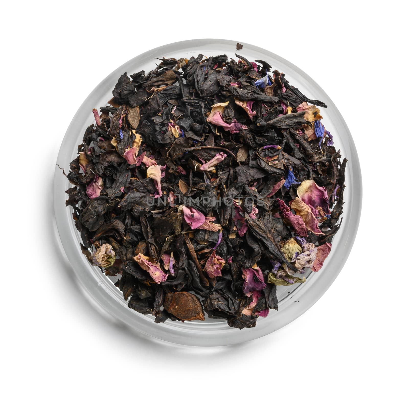 Black tea with natural aromatic additives. Top view on white background.