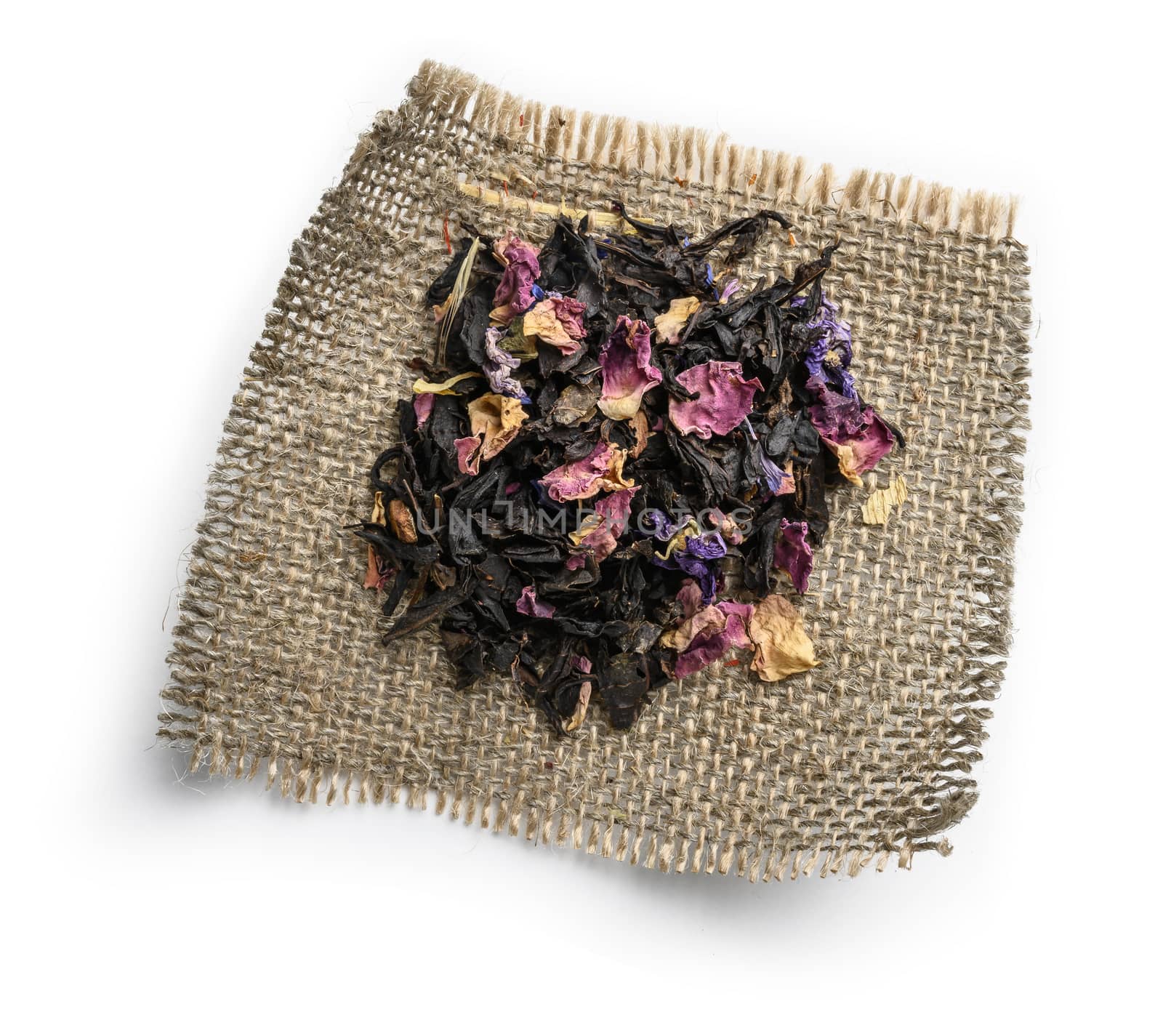 Black tea with natural aromatic additives. Top view on white background.