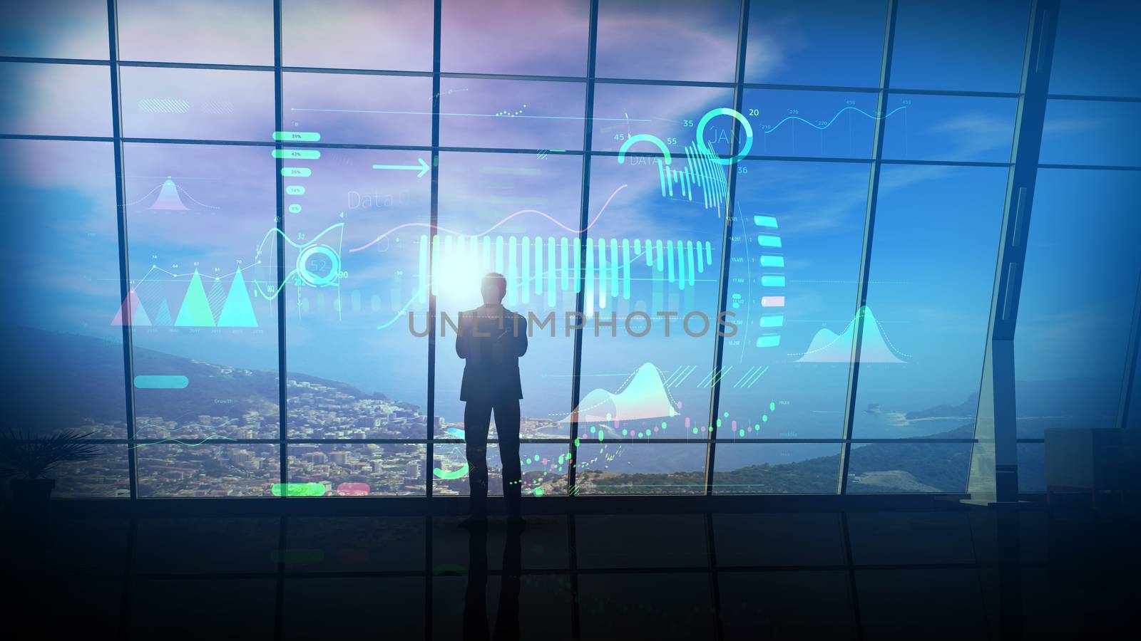 Silhouette of a businessman surrounded by virtual infographics in his office with panoramic window overlooking coastal landscape.