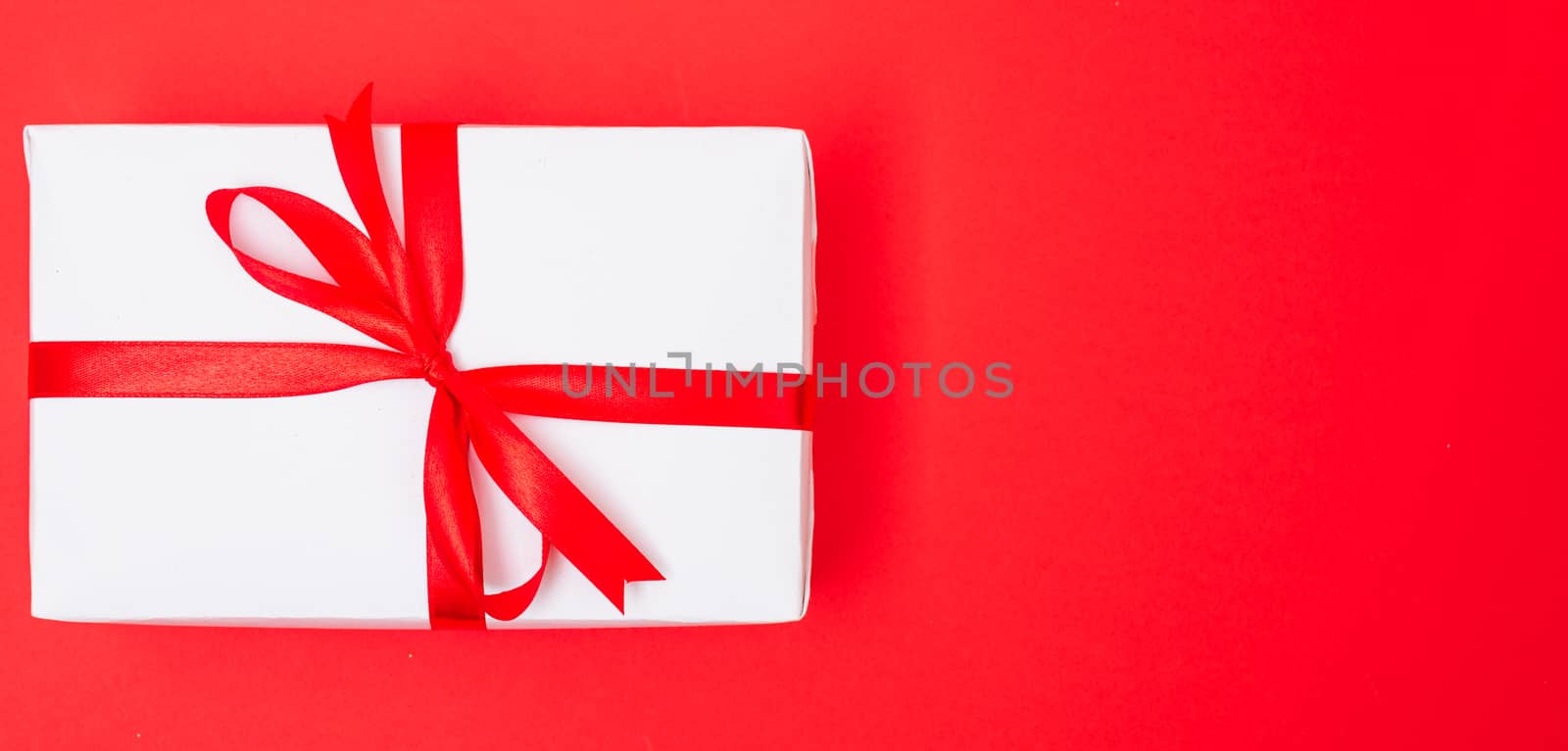 Happy New Year and Christmas 2020 or valentine day, top view Xmas white gift box on red background with copy space for your text