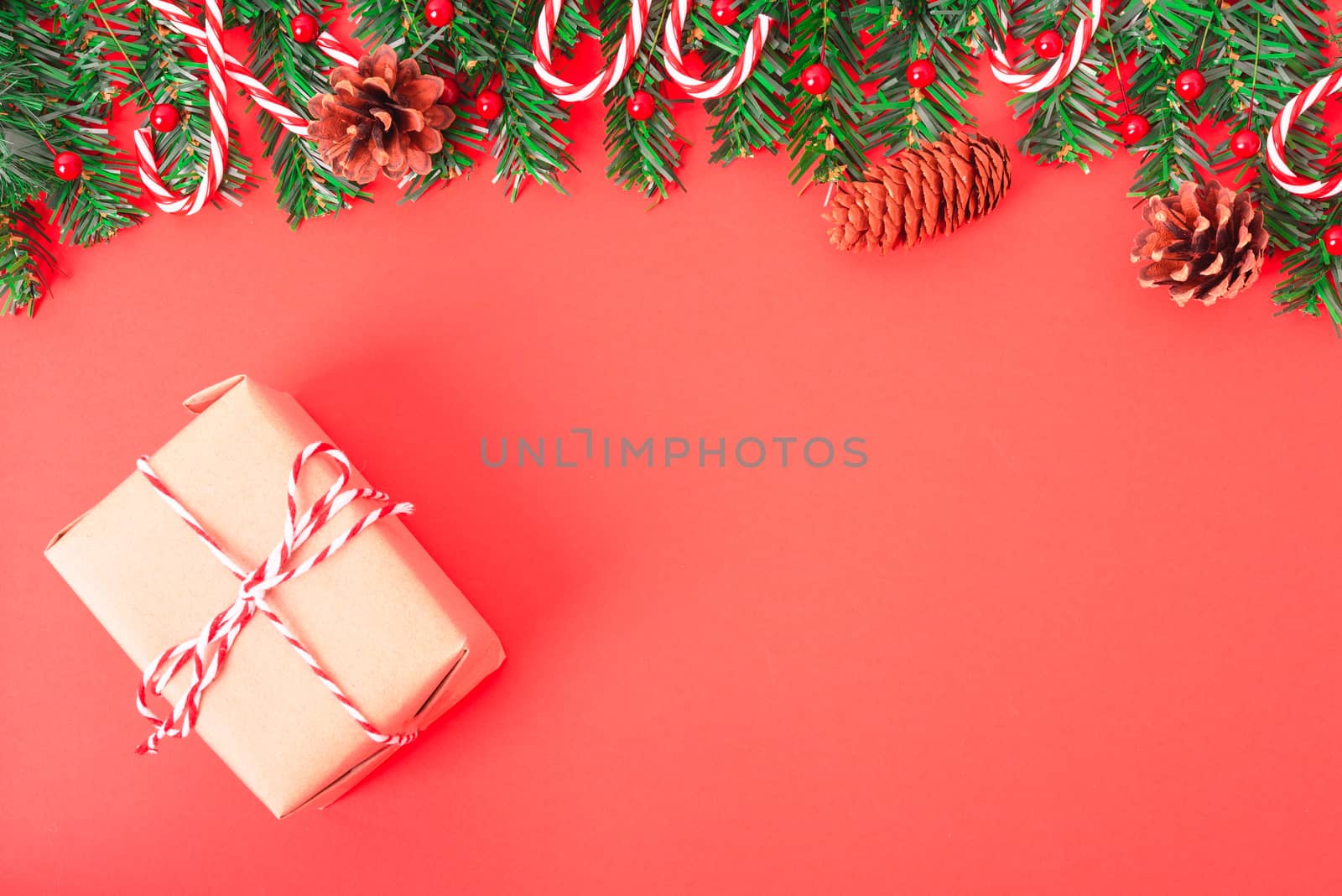 Happy New Year and Christmas day, top view flat lay composition decoration tree fir and gift box on red background with copy space for your text