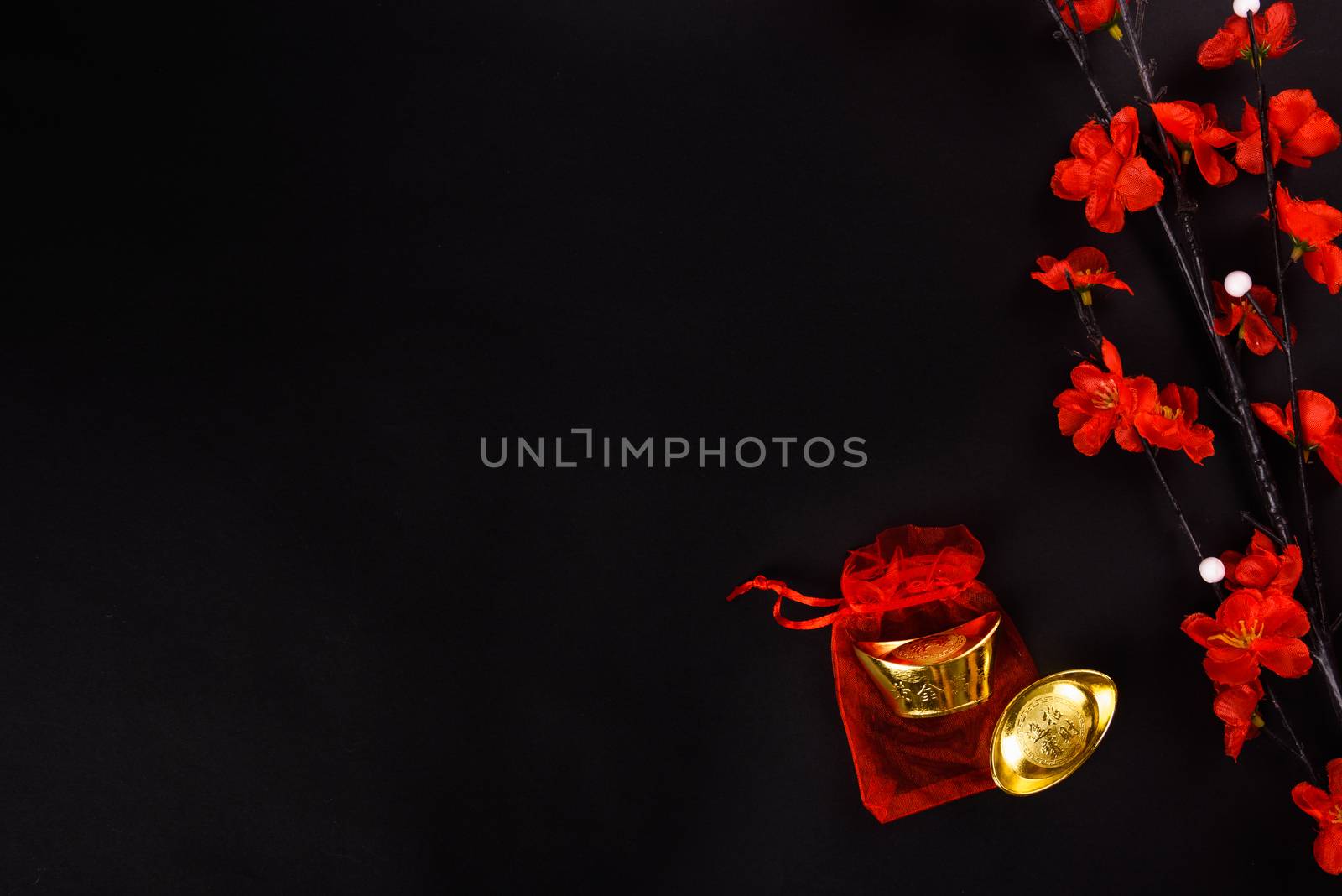 Chinese New Year, flat lay top view, gold bar and Chinese Flower on black background with copy space for your text