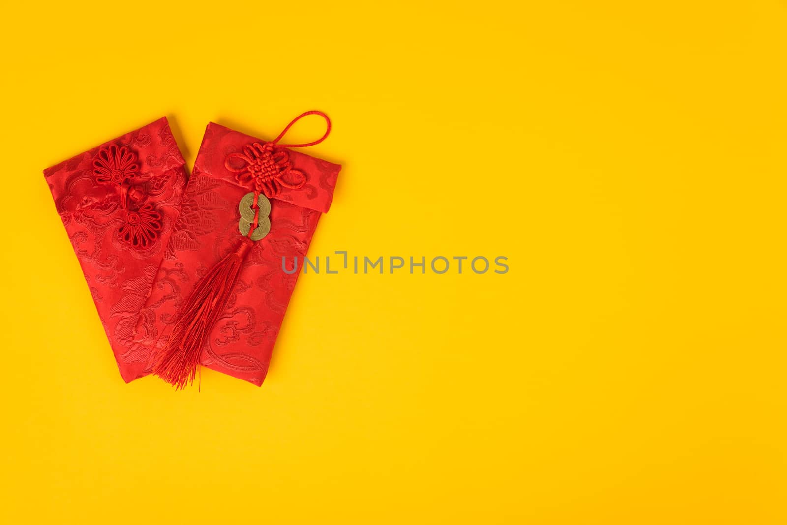 Chinese new year festival concept, flat lay top view, Happy Chinese new year with Red envelope (Character "FU" means fortune, blessing) on yellow background with copy space for text