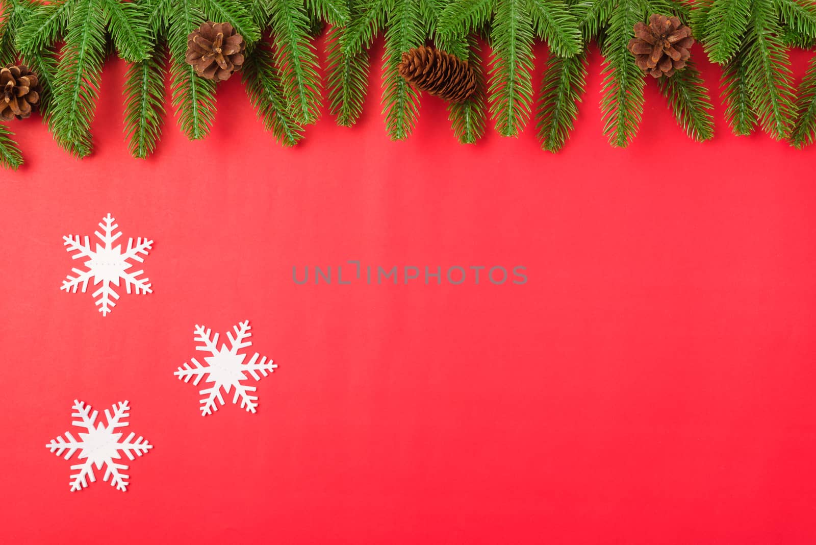 Happy new year or christmas day top view flat lay fir tree branches and decoration on red background with copy space for your text