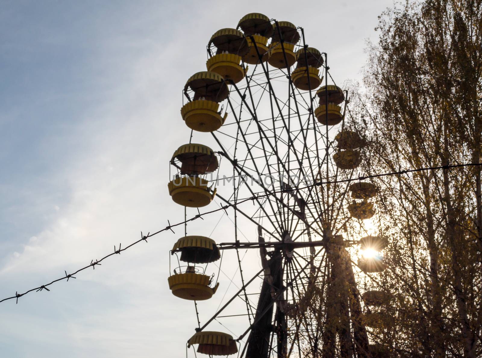 barbed wire and cabins old carousel wheel in an abandoned amusement park in Chernobyl Ukraine in autumn