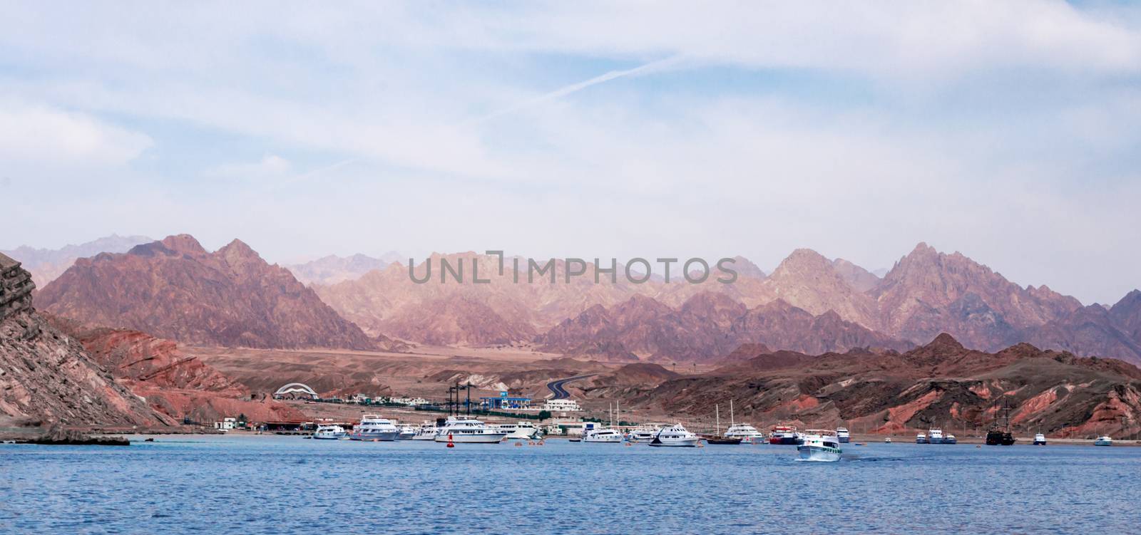 cruise boats near the rocky shore in Sharm El Sheikh Egypt