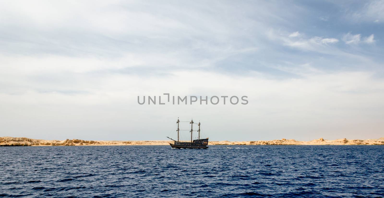 black yacht near the rocky shore of the Red Sea in Sharm El Sheikh Egypt