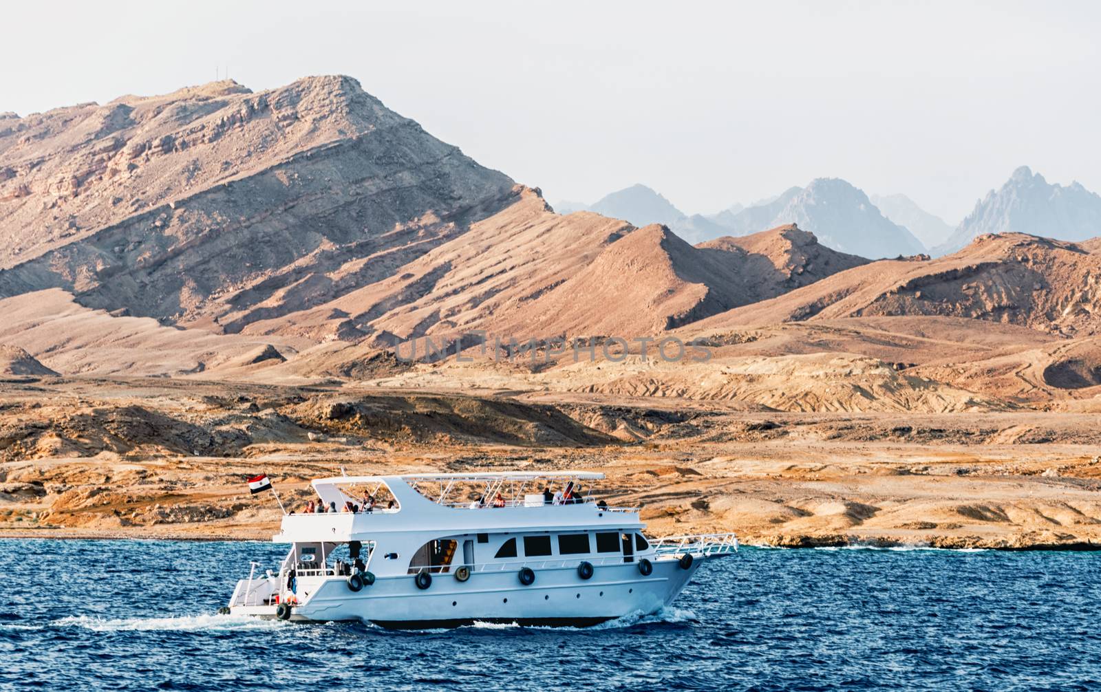 white cruise boat near the rocky shore in Sharm El Sheikh Egypt