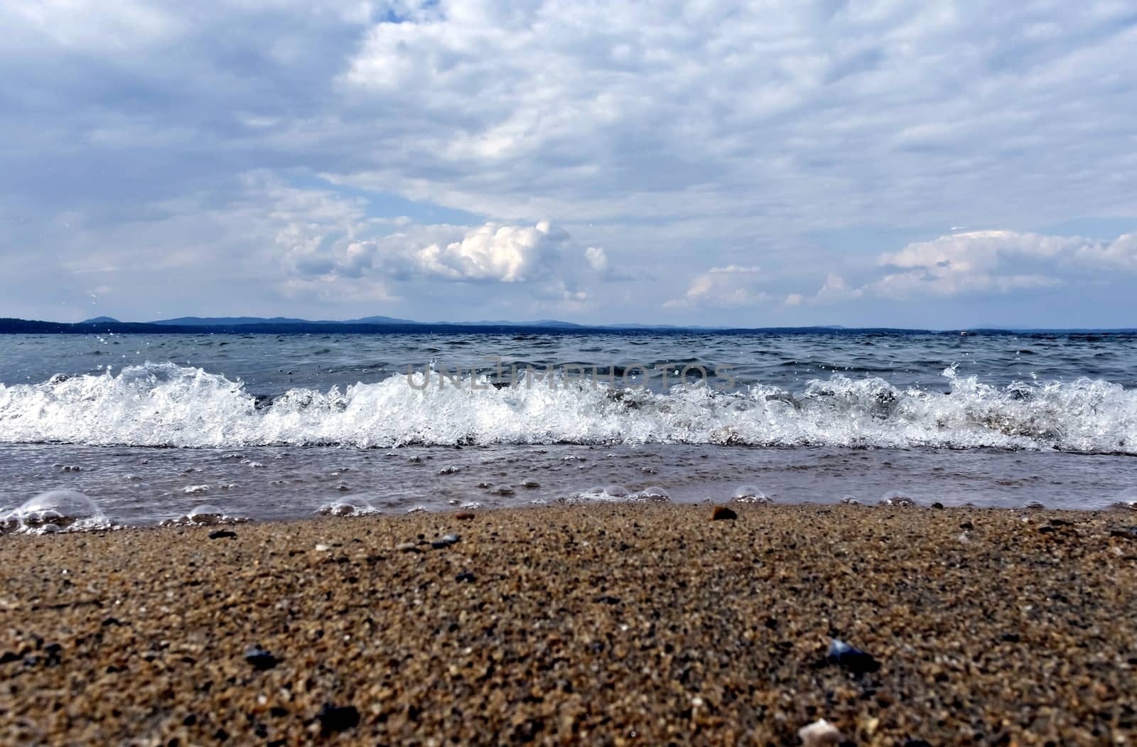 view of the lake with cumulonimbus clouds above it in windy weather, low point shooting