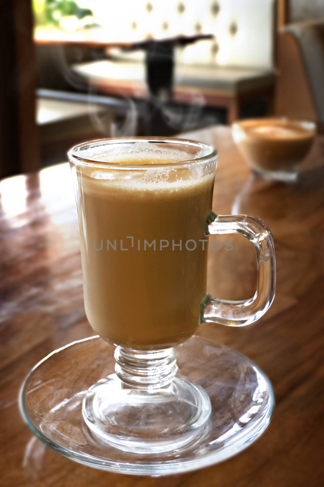 Cup of hot coffee latte on wood table in restaurant